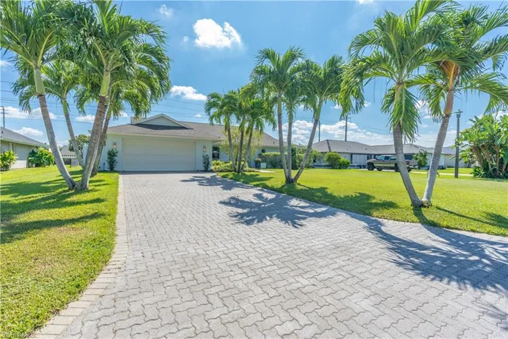 Single story home featuring a front yard and a garage