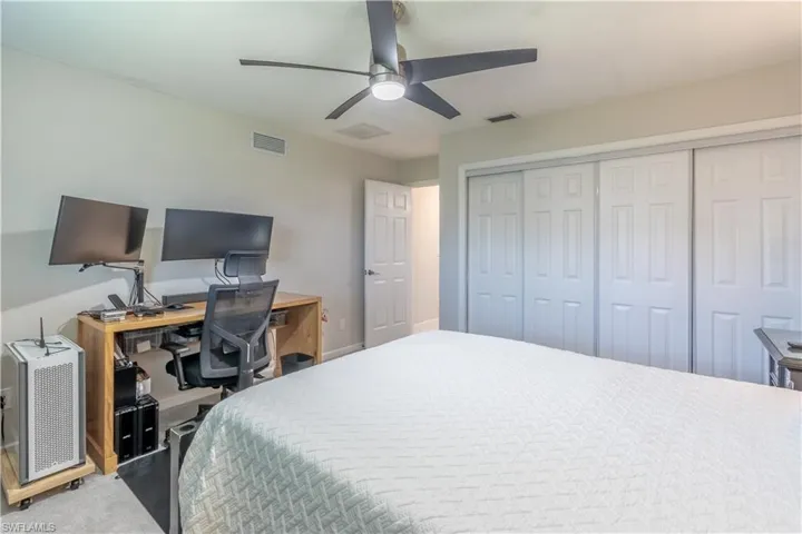 Bedroom with a closet, ceiling fan, and carpet floors