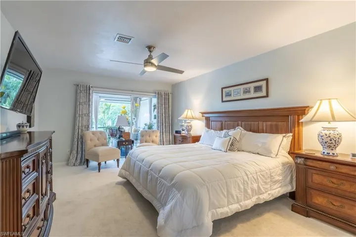 Bedroom featuring ceiling fan and light colored carpet