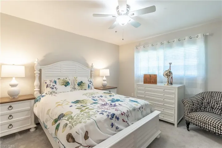Bedroom featuring ceiling fan and light colored carpet