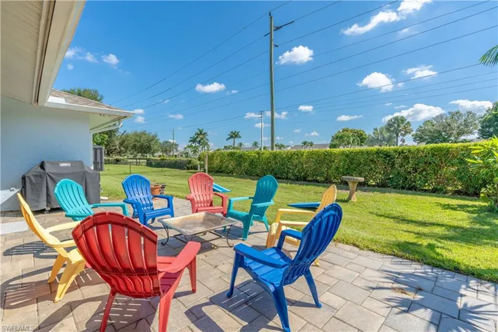 View of patio featuring area for grilling and a fire pit
