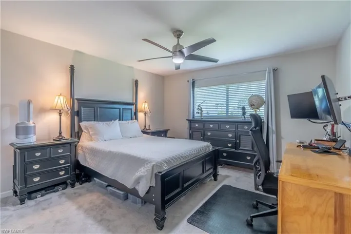 Carpeted bedroom with ceiling fan