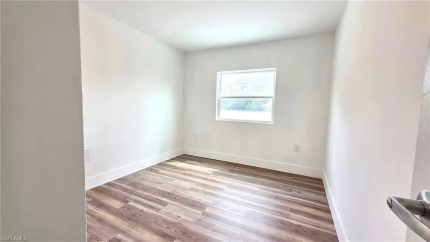 Spare room with light wood-style floors and baseboards
