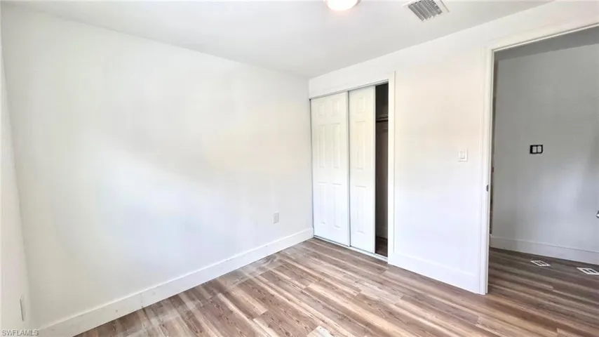 Unfurnished bedroom featuring a closet and light wood-style floors