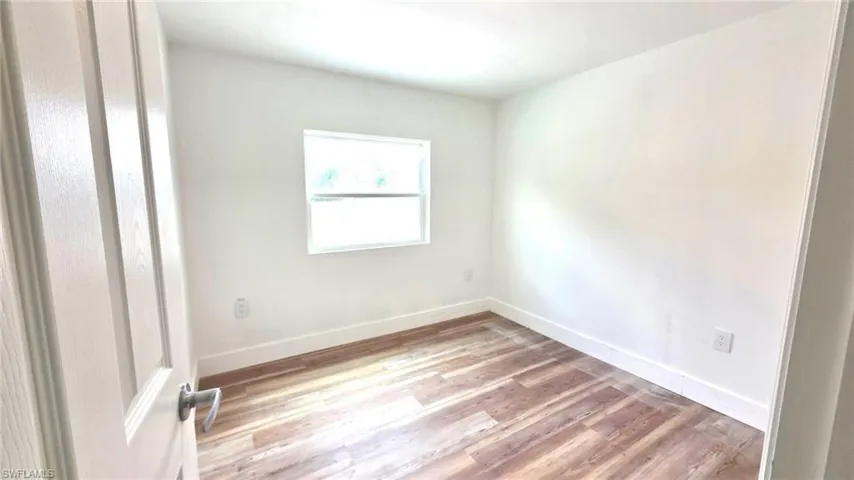 Empty room featuring light wood-style flooring and baseboards