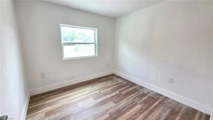 Empty room featuring light wood-style flooring and baseboards