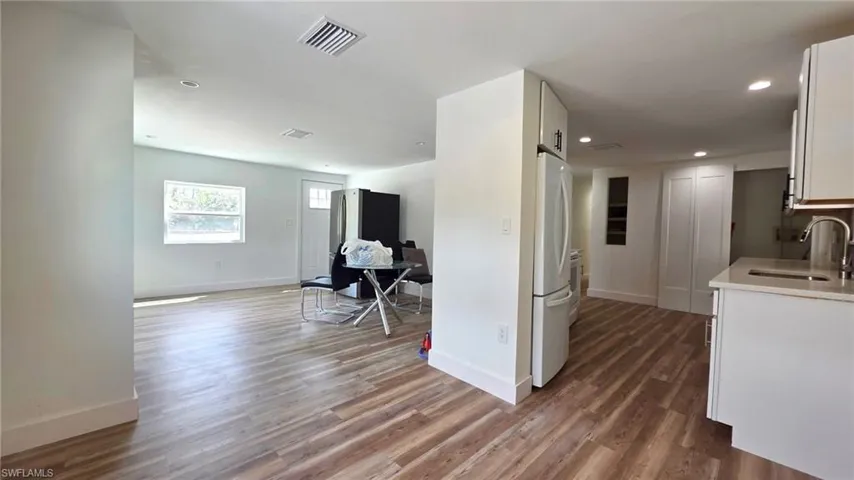 Corridor featuring dark wood finished floors and recessed lighting
