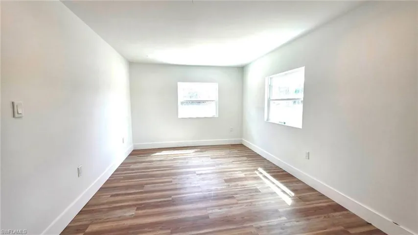 Empty room with wood finished floors and baseboards