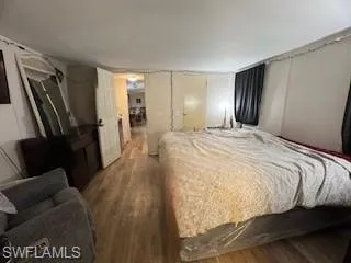 Bedroom featuring a textured ceiling and wood finished floors