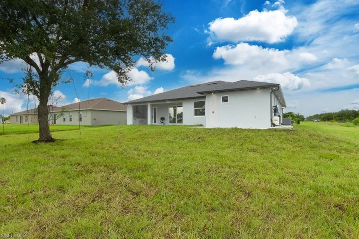 Rear view of property featuring a yard