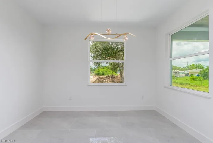 Unfurnished room with an inviting chandelier