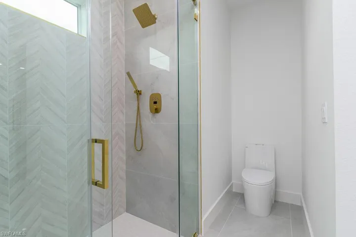 Bathroom featuring toilet and an enclosed shower