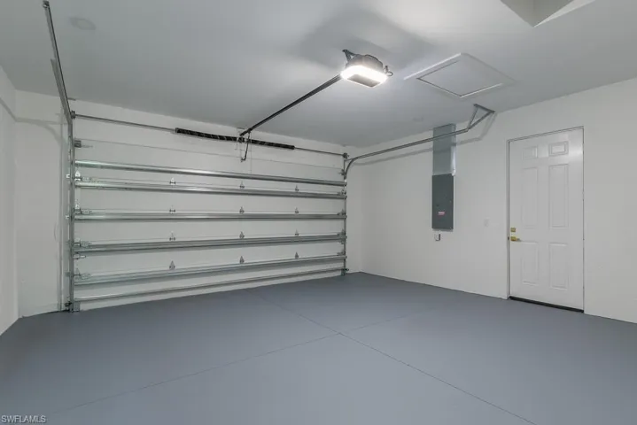 Garage with a garage door opener and electric panel