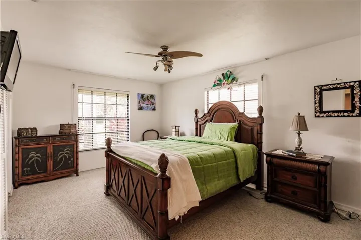 Bedroom featuring carpet and ceiling fan