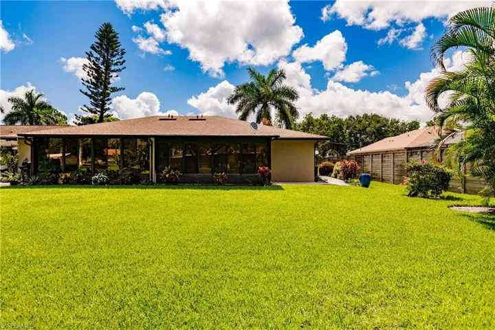 Back of house with a lawn