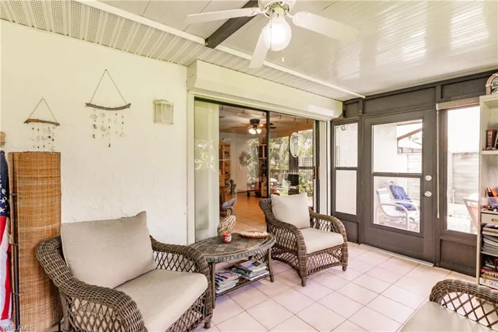 Sunroom featuring plenty of natural light and ceiling fan