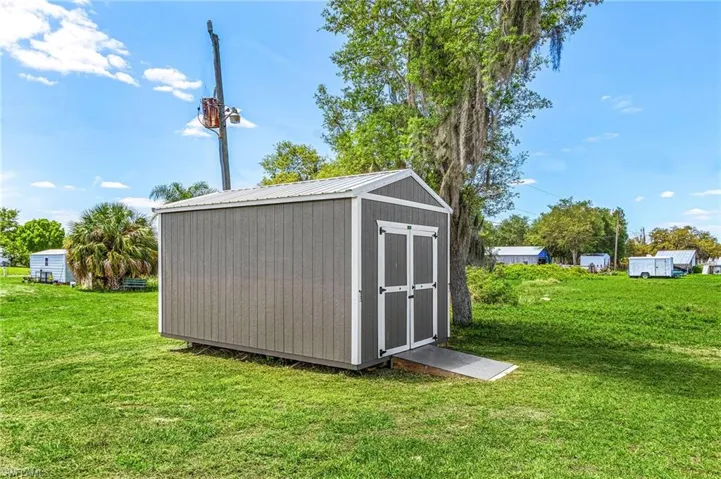 Storage Shed with hurricane strapping, double doors and ramp, hurricane shutters stored in shed