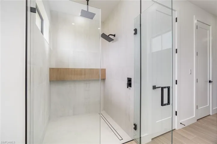 Bathroom featuring a shower with door and hardwood / wood-style floors