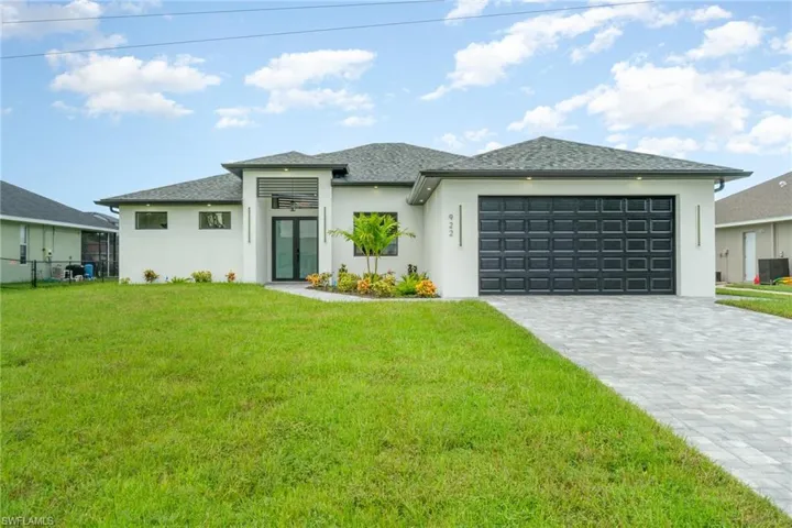 Prairie-style home with a garage and a front lawn