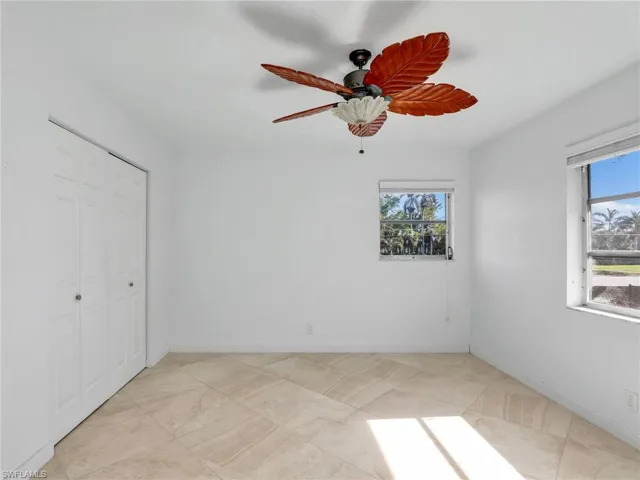 Unfurnished bedroom featuring a closet and a ceiling fan