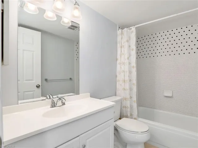 Full bath featuring vanity and shower / bath combo