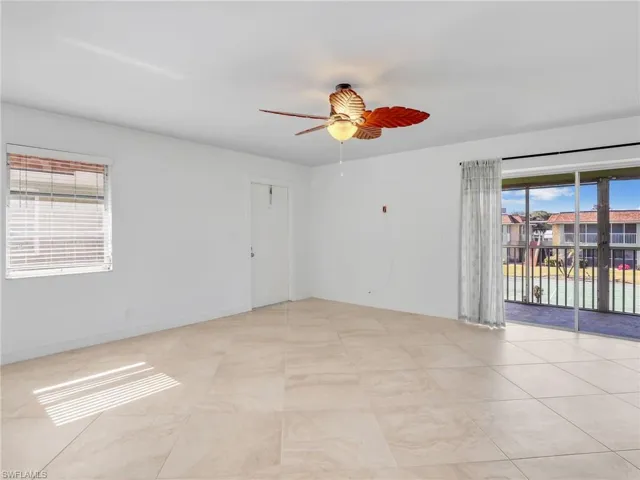 Unfurnished room featuring healthy amount of natural light and a ceiling fan