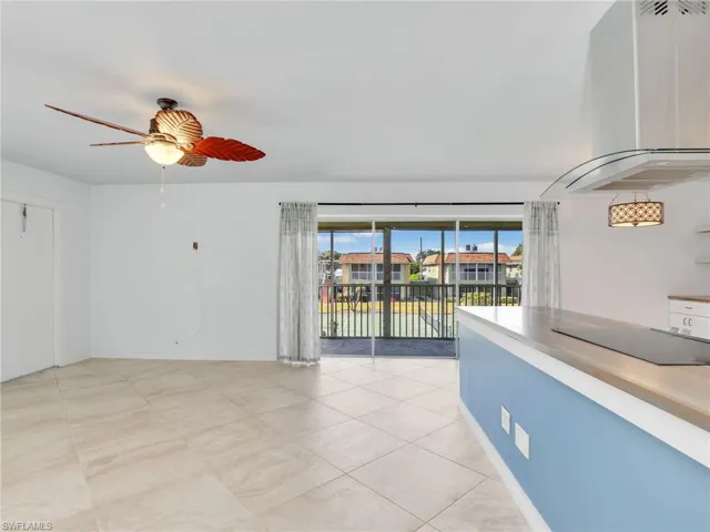 Spare room featuring ceiling fan, a residential view, and light tile patterned flooring