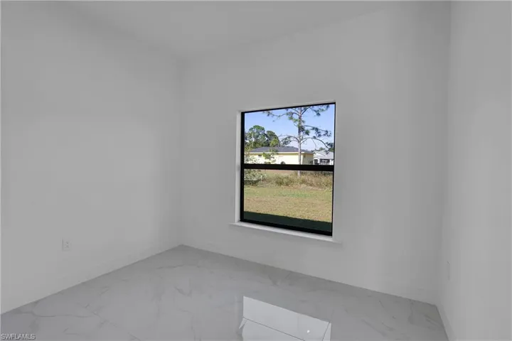 Empty room with light marble finish floors and baseboards