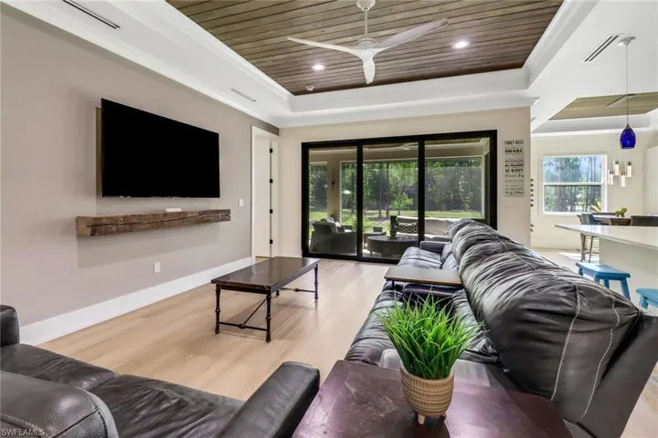 Living room with crown molding, and tongue and grove ceilings.