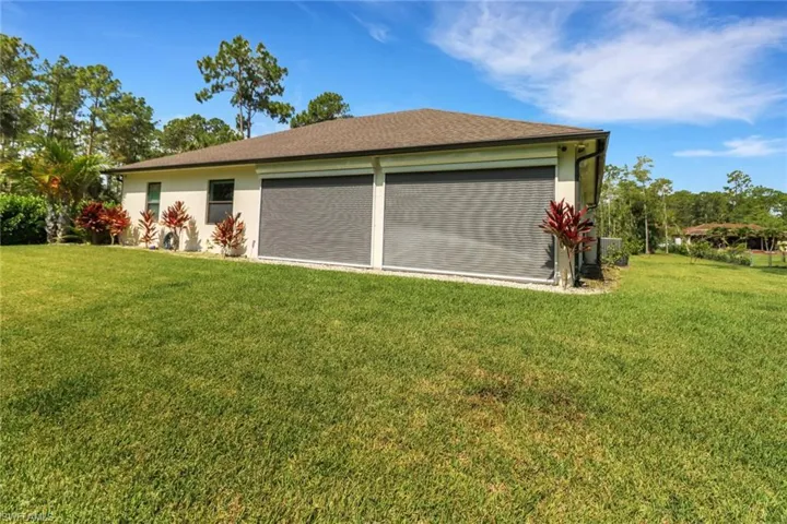 Back of house, featuring electric hurricane shutters