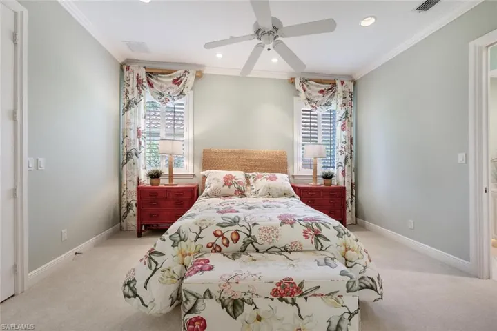 Guest bedroom 1 with planation shutters, recessed lighting and  ensuite