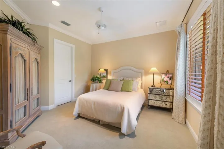Guest Bedroom 2 with plantation shutters and walk in closet