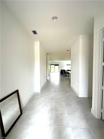 Hallway with light tile patterned floors