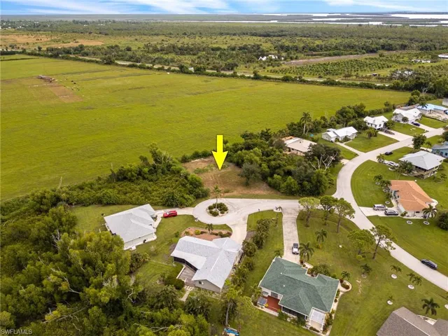 Aerial view of property's location featuring nearby suburban area and rural landscape