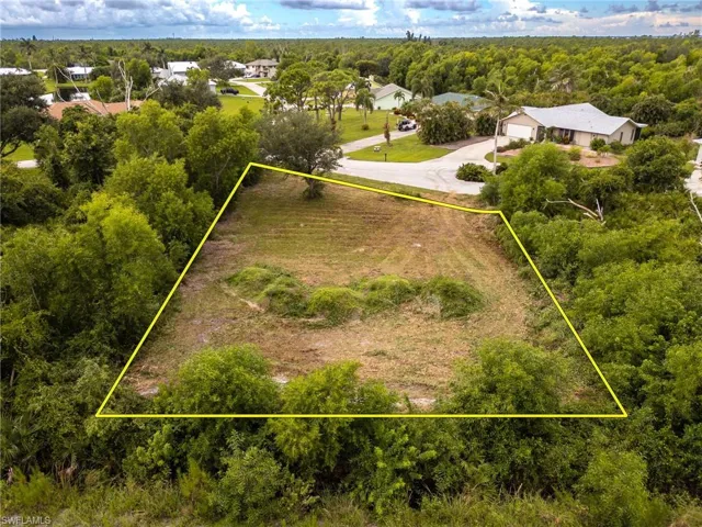 Aerial view of property's location featuring a forest and property parcel outlined