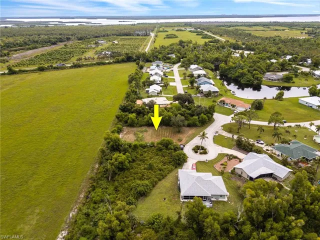 Aerial perspective of suburban area featuring a nearby body of water