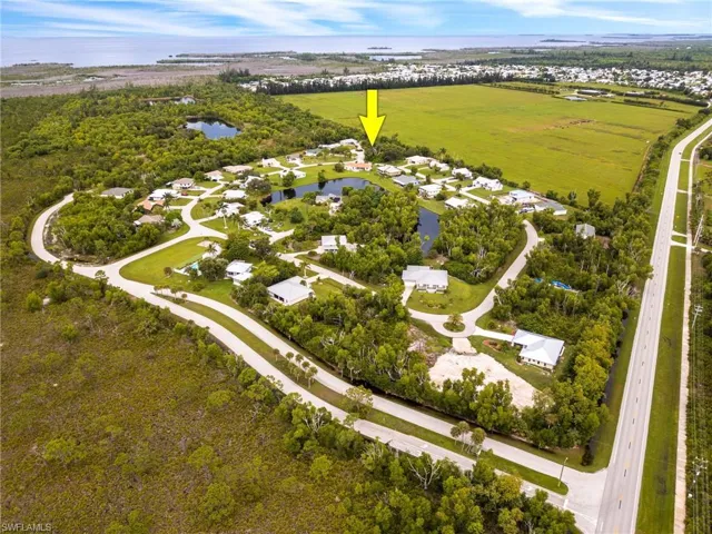 View of property location featuring a large body of water and nearby suburban area