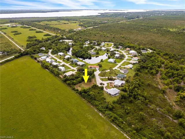 Aerial perspective of suburban area with a large body of water