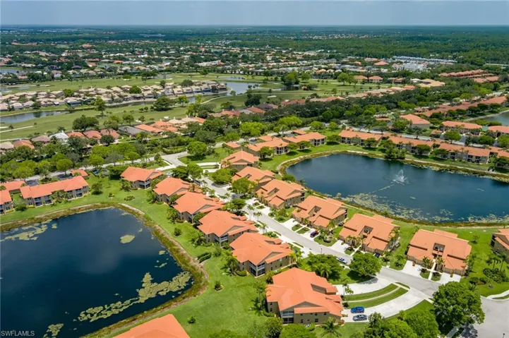 Aerial overview of property's location featuring a nearby body of water and nearby suburban area
