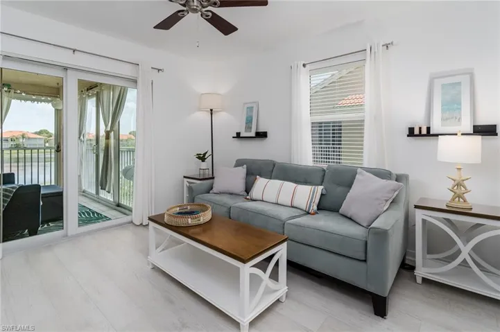 Living room featuring a ceiling fan and light wood-style flooring