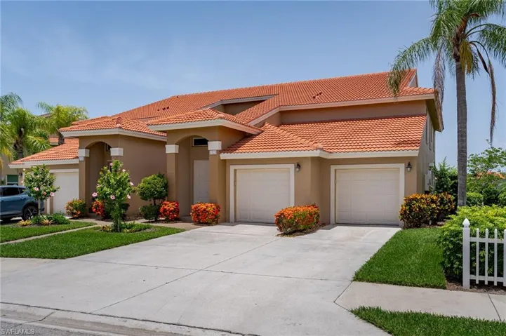 Mediterranean / spanish home with concrete driveway, stucco siding, a garage, and a tile roof