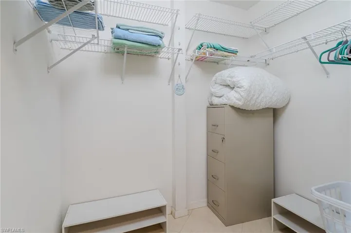 Walk in closet with light tile patterned floors
