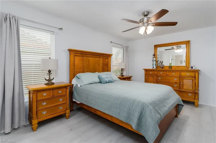 Bedroom with light wood-type flooring and a ceiling fan