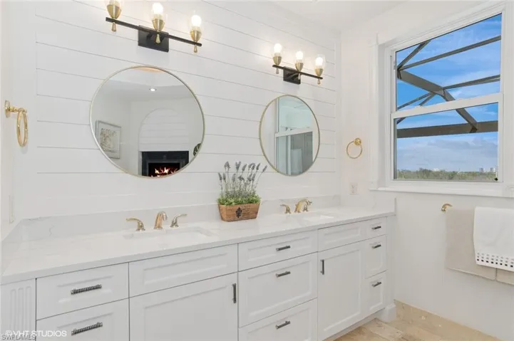 Full bathroom featuring a sink and double vanity