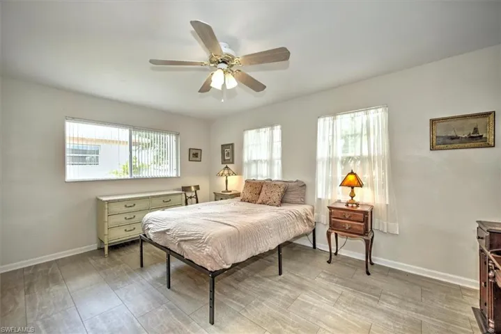 Bedroom with baseboards, light wood-style floors, and ceiling fan