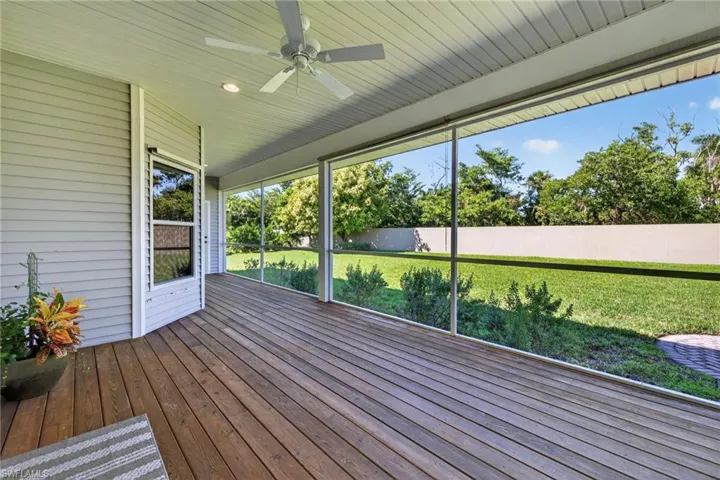 Unfurnished sunroom with ceiling fan