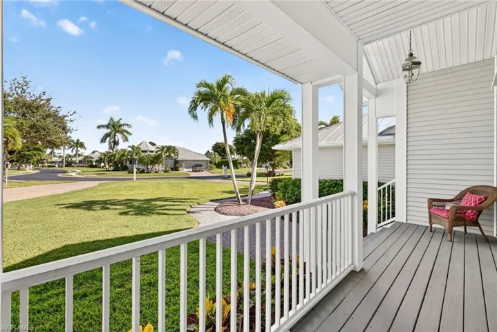 Porch with a residential view and a yard