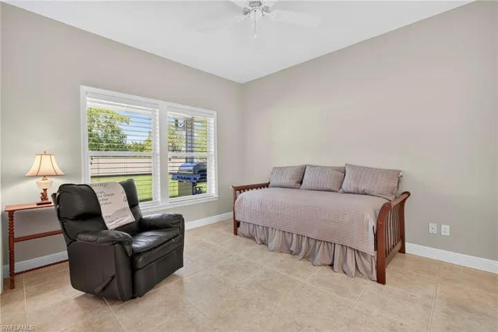 Bedroom featuring a ceiling fan and light tile patterned flooring