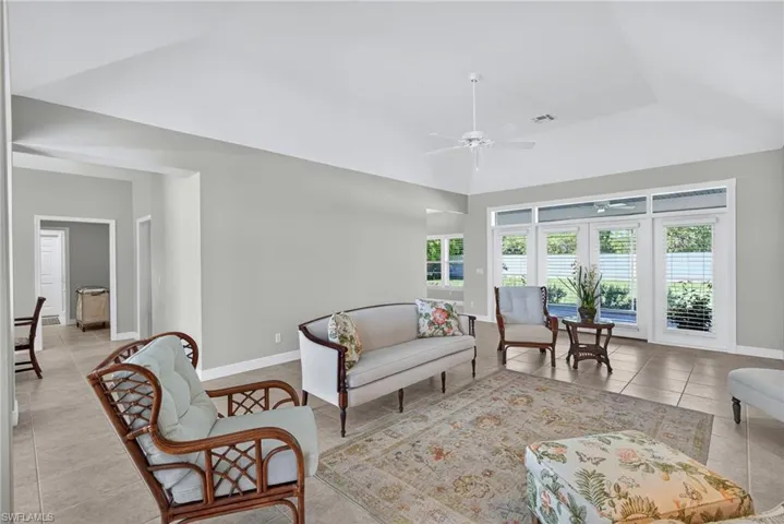 Living area featuring light tile patterned flooring and ceiling fan