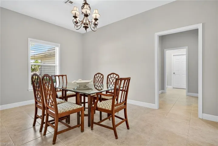 Dining space featuring a chandelier and light tile patterned floors